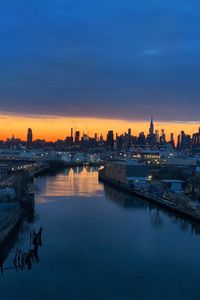 City at waterfront during sunset