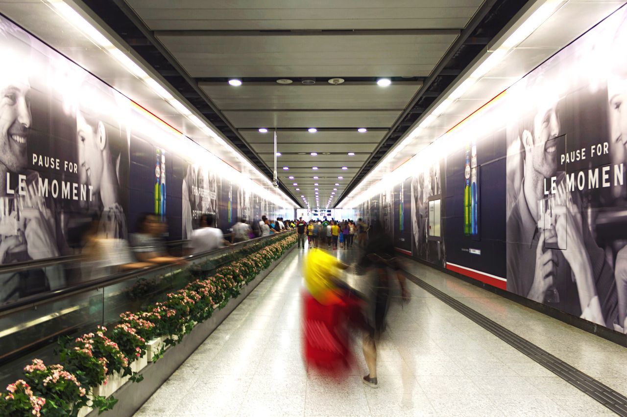 transportation, public transportation, rail transportation, railroad track, railroad station platform, indoors, illuminated, railroad station, subway station, mode of transport, the way forward, diminishing perspective, train - vehicle, built structure, text, architecture, travel, public transport, passenger train, incidental people