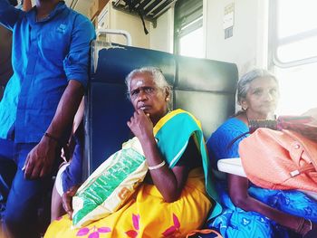 Rear view of people sitting in corridor