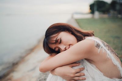 Portrait of happy woman lying on land