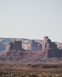 Rock formations on landscape against clear sky