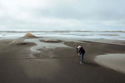 Full length of man on beach against sky