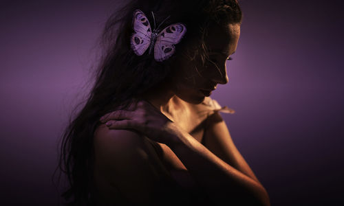 Portrait of a beautiful young woman over black background