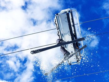 Low section of person traveling in ski lift