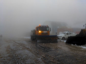 Car on road during winter at night