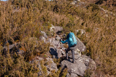 High angle view of person standing on rock