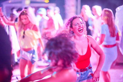 Young people dancing during party at nightclub