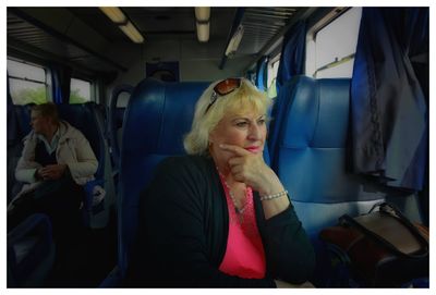 Portrait of woman sitting in train