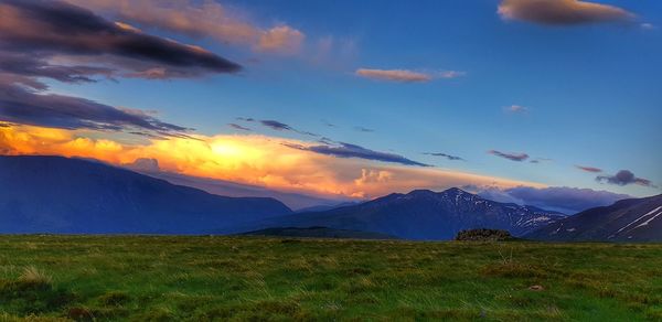 Scenic view of field against sky during sunset