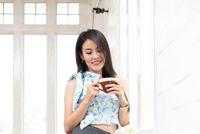 Young woman drinking coffee at home