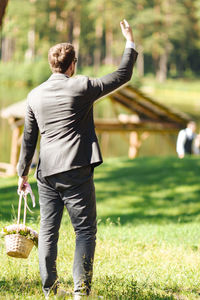 Rear view of man standing on field