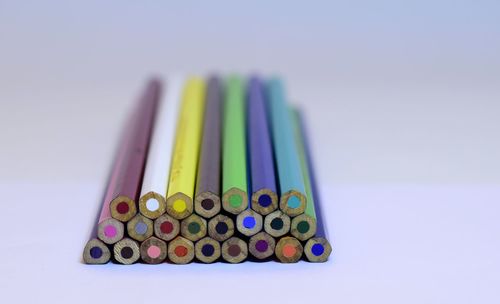 Close-up of colorful colored pencils over white background