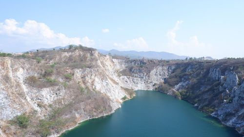 Panoramic view of river amidst mountains against sky