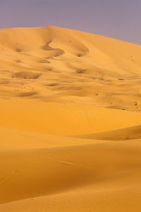 Scenic view of desert against sky during sunset