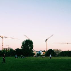 People walking on grassy field