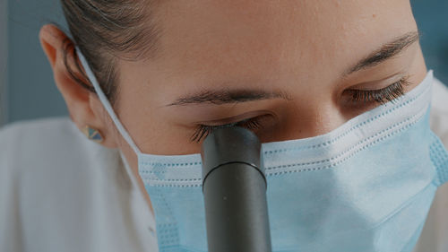 Close-up of young woman holding dental equipment