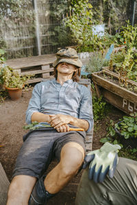 Male environmentalist resting at urban farm