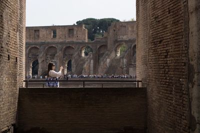 Man walking in front of historical building