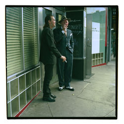 Full length portrait of young couple standing outdoors