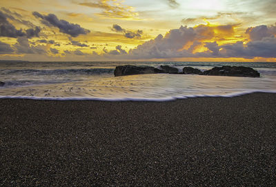 Scenic view of beach against sky during sunset