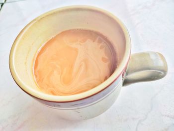 High angle view of coffee in cup on table