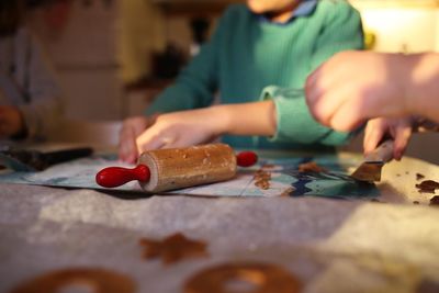 Close-up of hands on table while baking