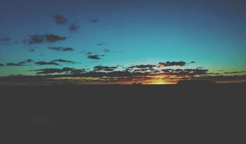 Scenic view of silhouette landscape against sky at sunset