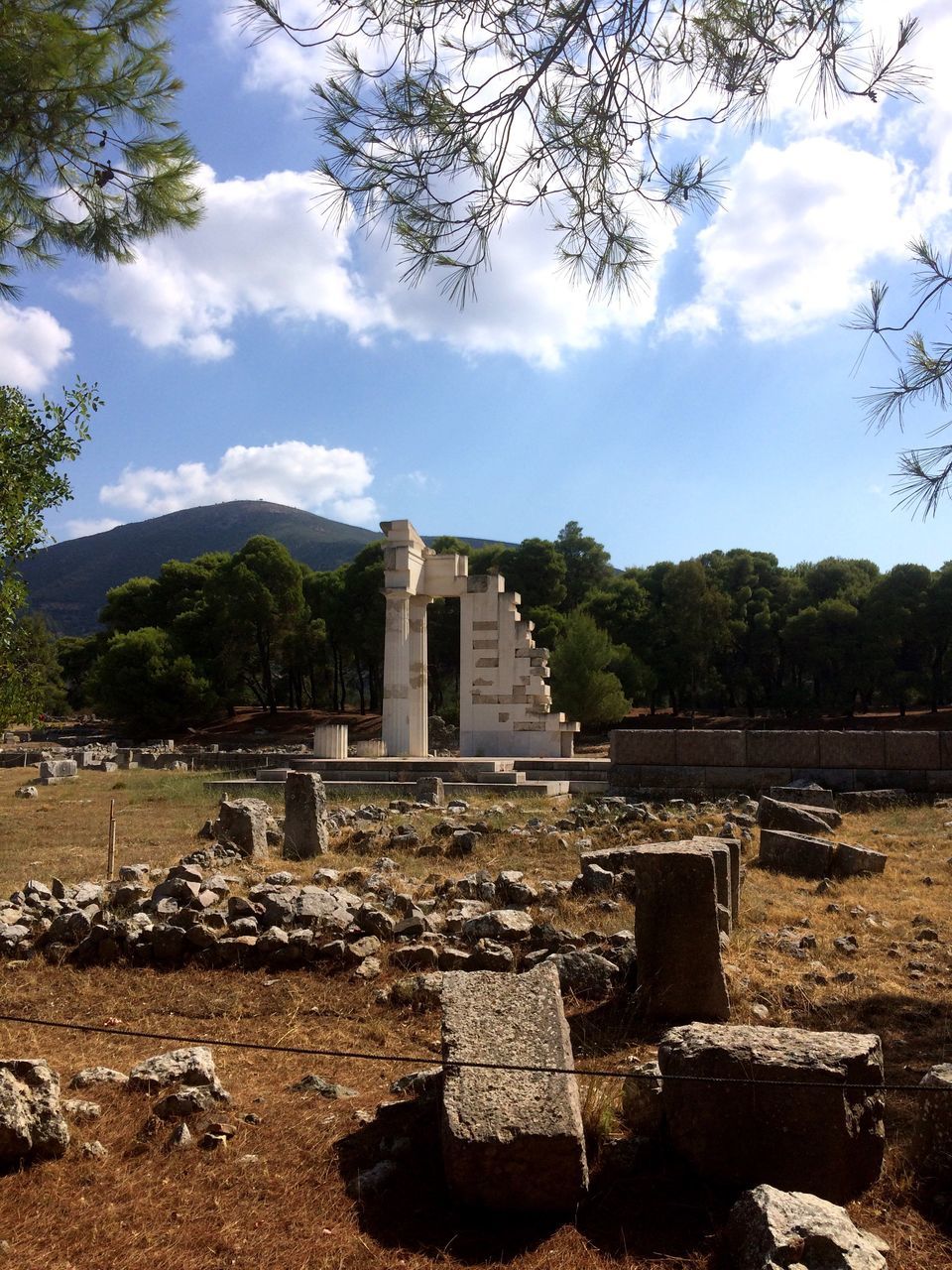 sky, history, tree, the past, old, old ruin, built structure, cloud - sky, memories, architecture, memorial, travel destinations, ancient civilization, ruined, cloud, ancient, monument, tourism, famous place, stone material, day, outdoors, damaged, place of burial, archaeology