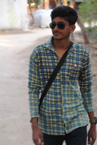 Young man wearing sunglasses standing outdoors