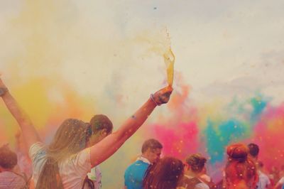 People throwing colored holi powder