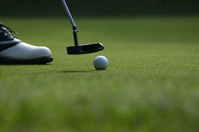 Low section of man playing golf