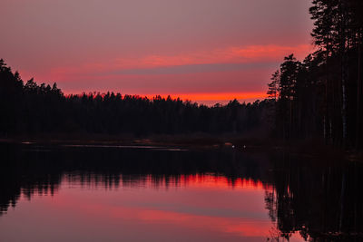 Scenic view of lake against romantic sky at sunset