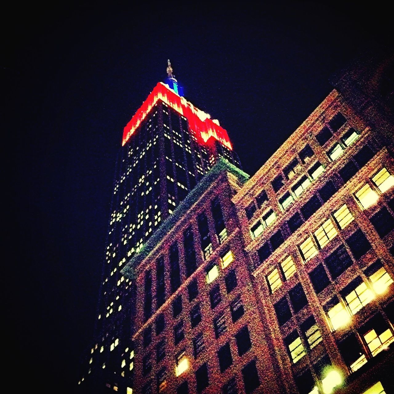 architecture, building exterior, built structure, low angle view, night, illuminated, city, clear sky, tower, building, tall - high, sky, window, outdoors, no people, residential building, skyscraper, lighting equipment, clock tower, city life