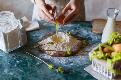 Midsection of woman preparing food on cutting board