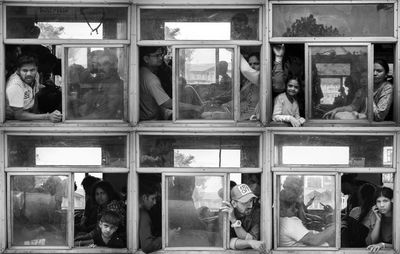 Reflection of people on glass window