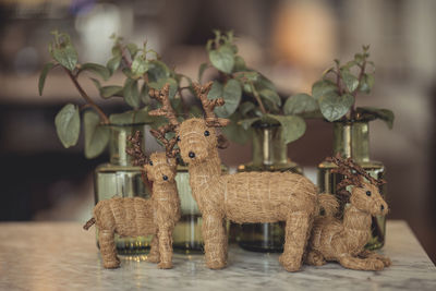 Close-up of deer with stuffed toy on table