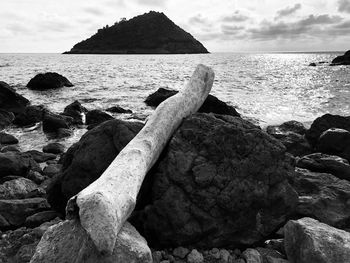 Scenic view of rocks on beach against sky