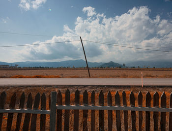 Fence on field against sky