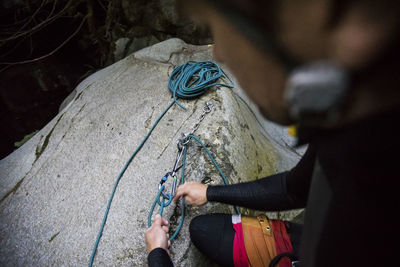 High angle view of climber setting up rappel station in canyon.