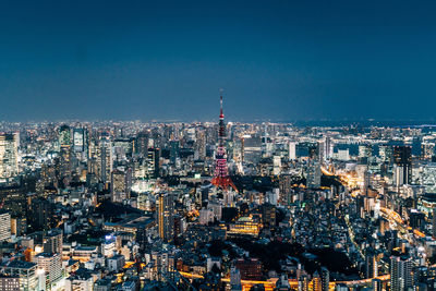 Aerial view of city lit up at night