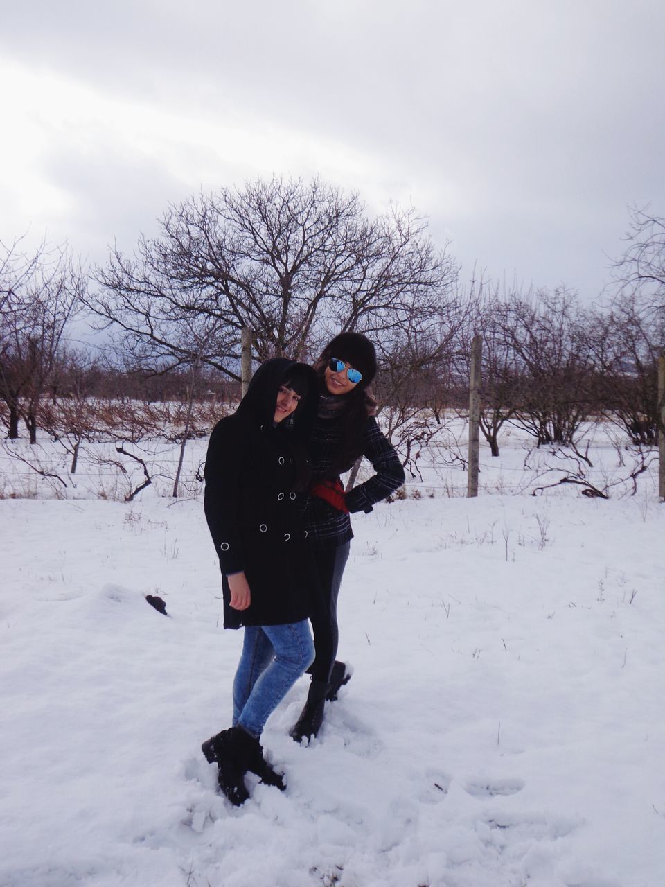 snow, winter, cold temperature, season, weather, bare tree, lifestyles, leisure activity, warm clothing, field, full length, covering, landscape, tree, frozen, white color, sky, nature