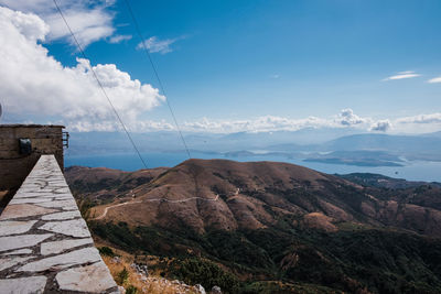 Scenic view of mountains against cloudy sky