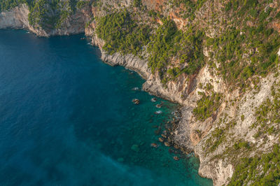 View of turquoise sea at the foot of cliffs in the rocky coast of zakynthos