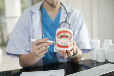 Midsection of doctor examining patient in clinic