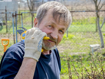 Portrait of man holding pruning shears