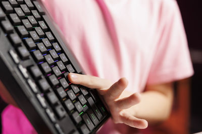 Midsection of woman using laptop