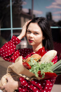 Portrait of smiling young woman looking away