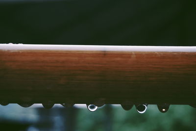Close-up of raindrops on metal during rainy season