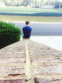 Rear view of woman walking on footpath