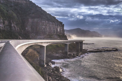 Scenic view of bridge over mountain against sky